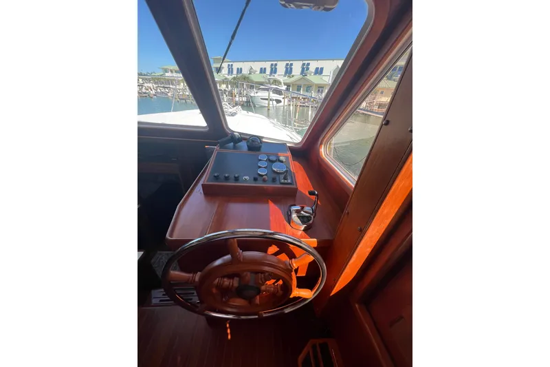 Slide: The Image of Helm of 2007 Heritage East 36 Sundeck Trawler with wooden steering wheel and control panel. - 14