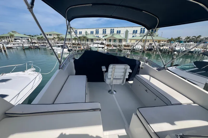 Slide: The Image of Flybridge of 2007 Heritage East 36 Sundeck Trawler at marina, featuring seating and canopy. - 7