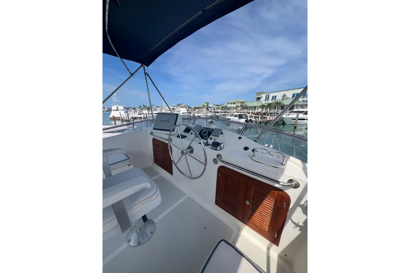 Slide: The Image of Helm of 2007 Heritage East 36 Sundeck Trawler with marina view. - 8