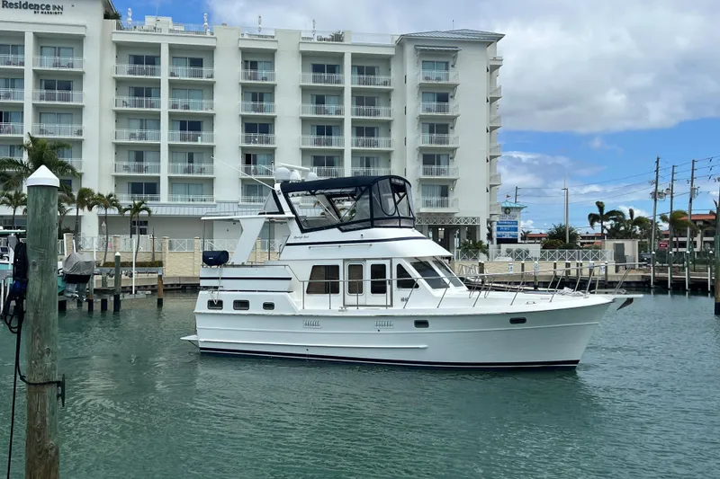 The Image of 2007 Heritage East 36 Sundeck Trawler docked near a waterfront hotel. - 0