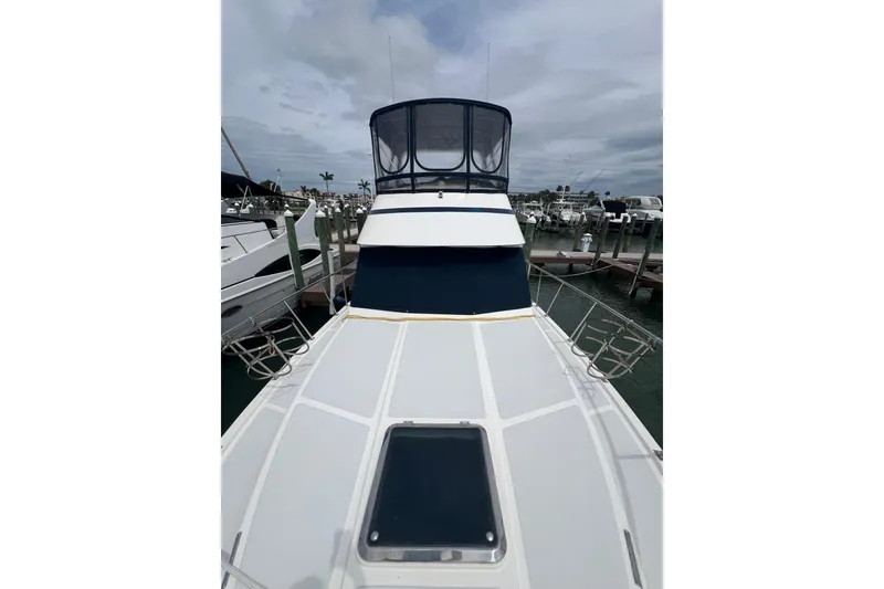 Slide: The Image of 2007 Heritage East 36 Sundeck Trawler docked, showcasing spacious deck and enclosed helm. - 31