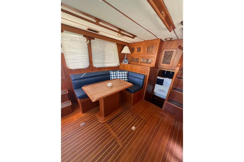 Slide: The Image of Interior of 2007 Heritage East 36 Sundeck Trawler with wooden furnishings and seating area. - 11