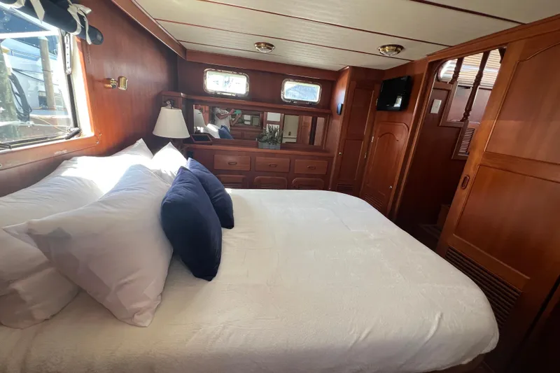 Slide: The Image of Luxurious bedroom interior of 2007 Heritage East 36 Sundeck Trawler with wood paneling. - 19