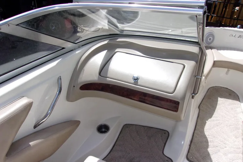 Slide: The Image of 2006 Glastron GXL 205 boat interior with beige upholstery and sleek dashboard design. - 5