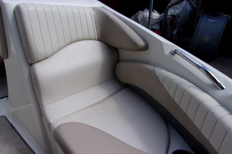 Slide: The Image of 2006 Glastron GXL 205 boat seat with beige and white upholstery, featuring a chrome handle. - 13