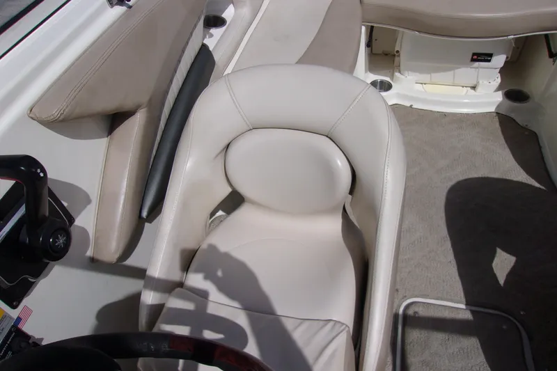 Slide: The Image of 2006 Glastron GXL 205 boat interior with beige seating and steering wheel. - 6