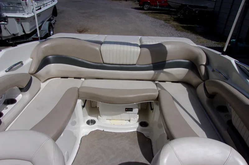 Slide: The Image of 2006 Glastron GXL 205 boat interior with beige seating and cup holders. - 8