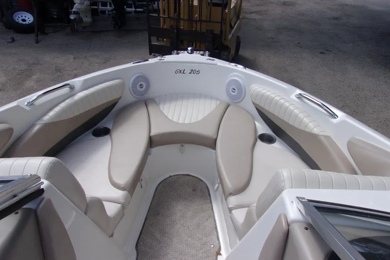 Slide: The Image of 2006 Glastron GXL 205 boat interior with beige seating and cup holders. - 12