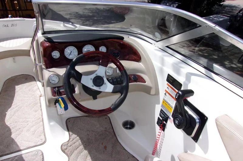 Slide: The Image of 2006 Glastron GXL 205 boat dashboard with steering wheel and control panel. - 4