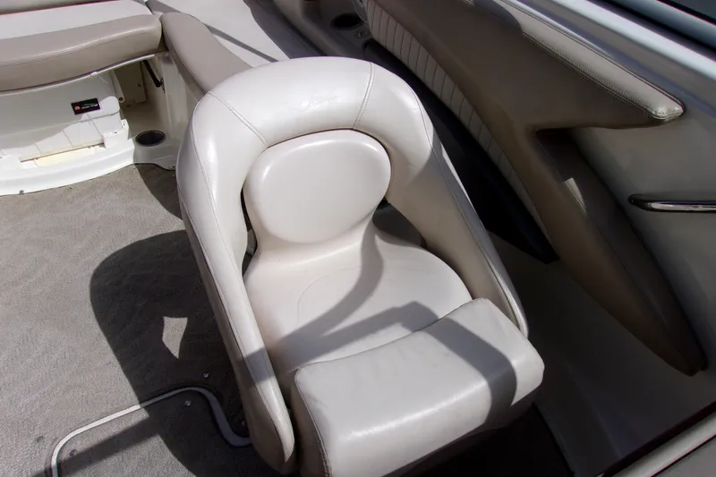 Slide: The Image of 2006 Glastron GXL 205 boat interior with white leather seating and carpeted floor. - 7