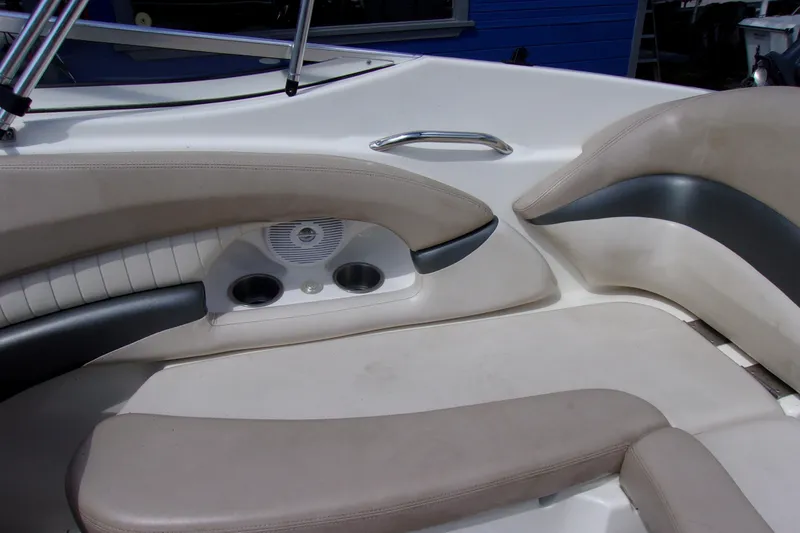 Slide: The Image of 2006 Glastron GXL 205 boat interior with beige seating and cup holders. - 9