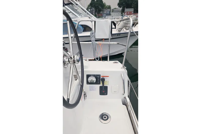 Slide: The Image of Cockpit view of 2022 Beneteau Oceanis 30.1 sailboat with steering wheel and controls. - 30