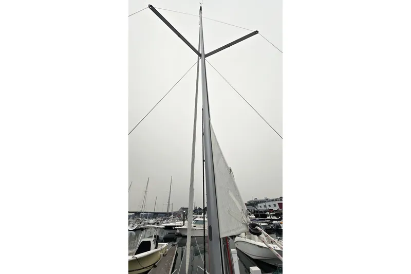 Slide: The Image of Sailboat mast of 2022 Beneteau Oceanis 30.1 in marina, overcast sky. - 10