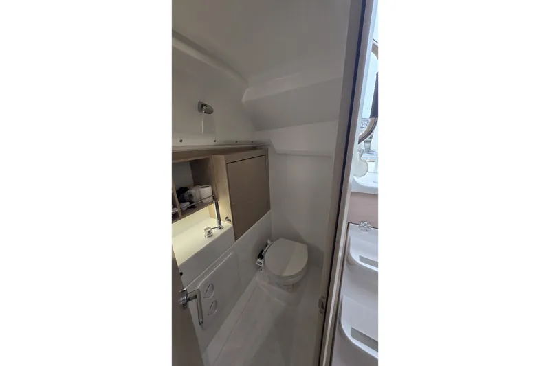 Slide: The Image of Compact bathroom in 2022 Beneteau Oceanis 30.1 yacht, featuring modern fixtures and storage. - 34