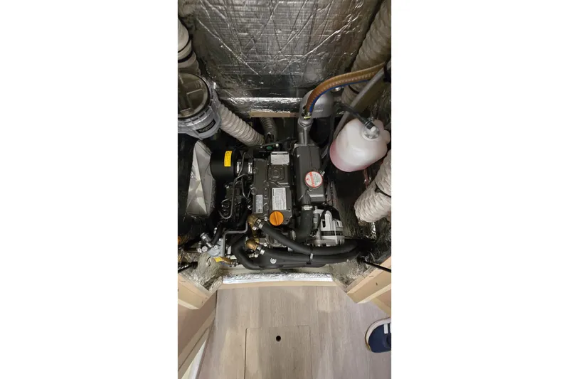 Slide: The Image of Engine compartment of a 2022 Beneteau Oceanis 30.1 sailboat, showcasing mechanical components. - 36