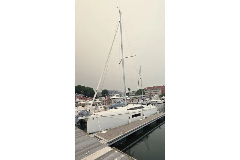 Slide: The Image of 2022 Beneteau Oceanis 30.1 sailboat docked at a marina. - 28