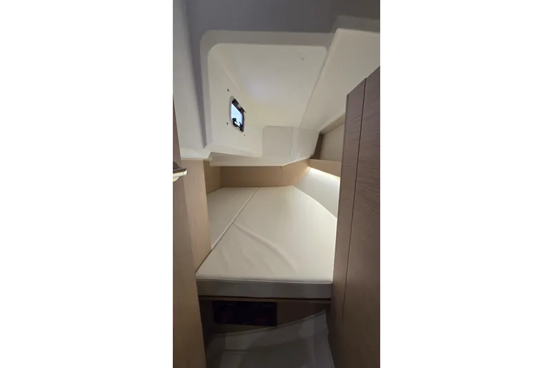 Slide: The Image of Interior cabin of 2022 Beneteau Oceanis 30.1 yacht, featuring a cozy sleeping area. - 26