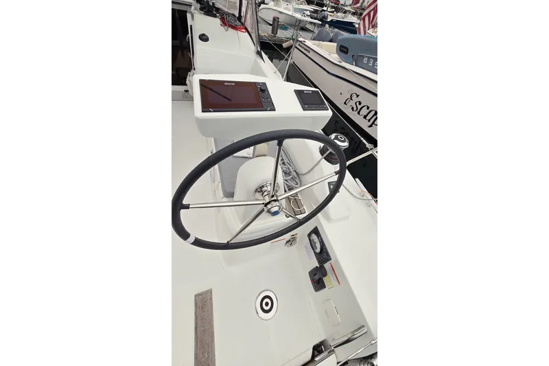 Slide: The Image of Steering wheel and controls of 2022 Beneteau Oceanis 30.1 sailboat at dock. - 12