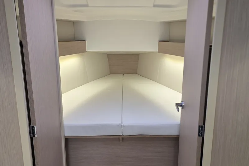 Slide: The Image of Interior cabin of 2022 Beneteau Oceanis 30.1 yacht, featuring cozy sleeping quarters. - 23