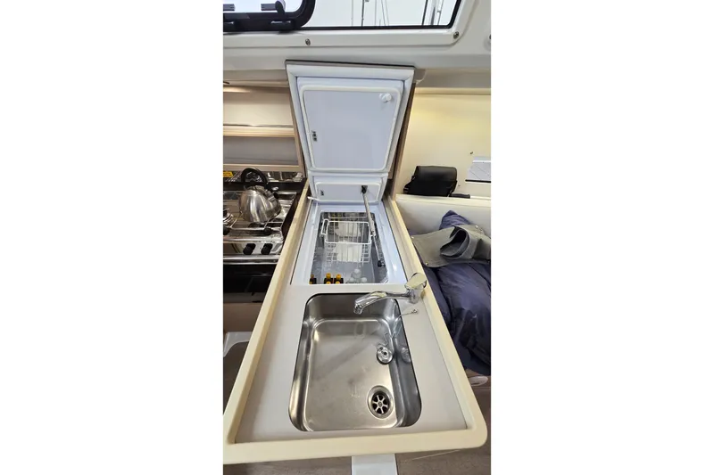 Slide: The Image of Beneteau Oceanis 30.1 yacht kitchen with sink and open refrigerator, 2022 model. - 5
