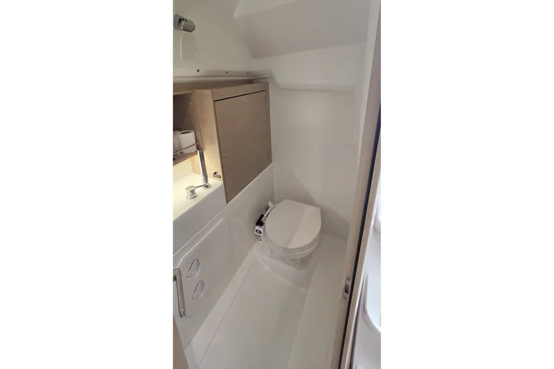 Slide: The Image of Bathroom interior of 2022 Beneteau Oceanis 30.1 yacht, featuring compact design and modern fixtures. - 25