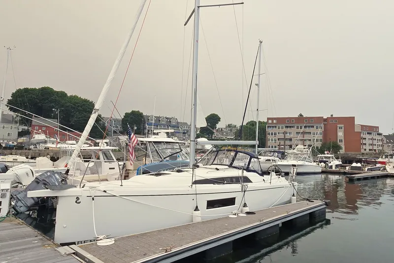 Slide: The Image of 2022 Beneteau Oceanis 30.1 yacht docked in a marina with surrounding boats. - 27