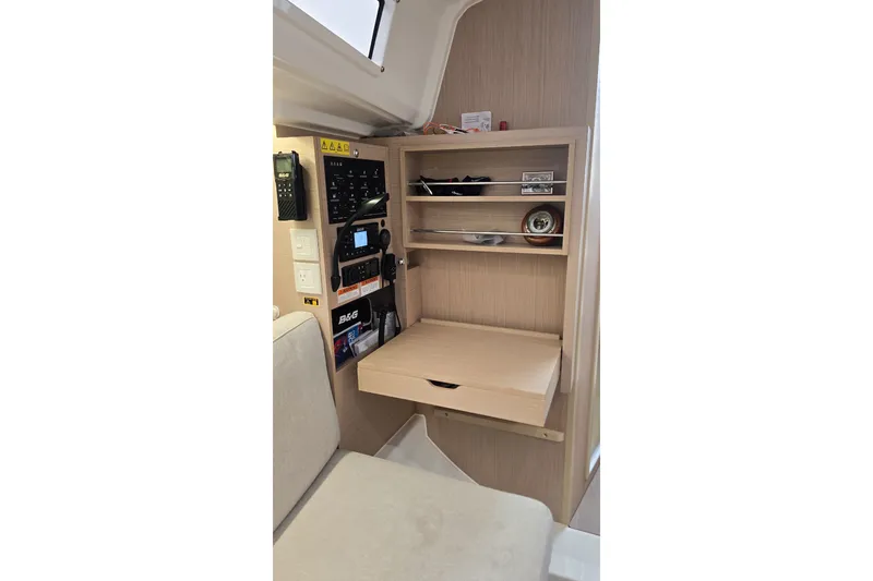 Slide: The Image of Interior of 2022 Beneteau Oceanis 30.1 yacht with navigation equipment and storage shelves. - 20