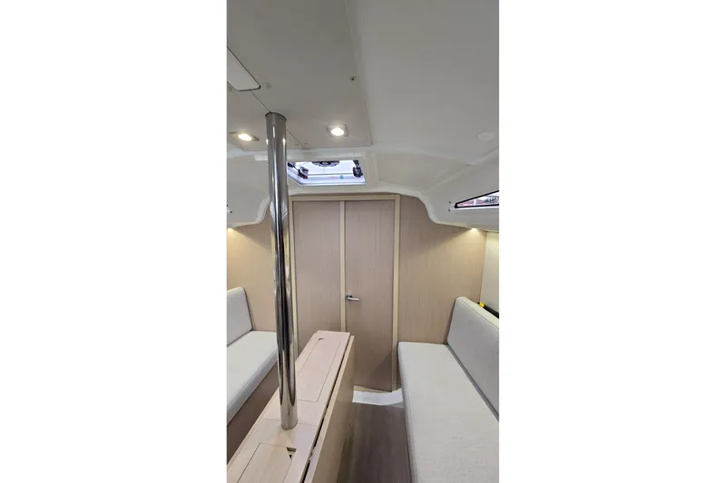 Slide: The Image of Interior of 2022 Beneteau Oceanis 30.1 sailboat, featuring modern seating and wooden finishes. - 24