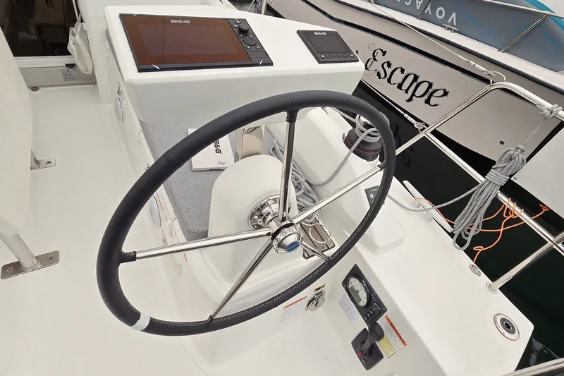 Slide: The Image of Steering wheel and controls of a 2022 Beneteau Oceanis 30.1 sailboat. - 11