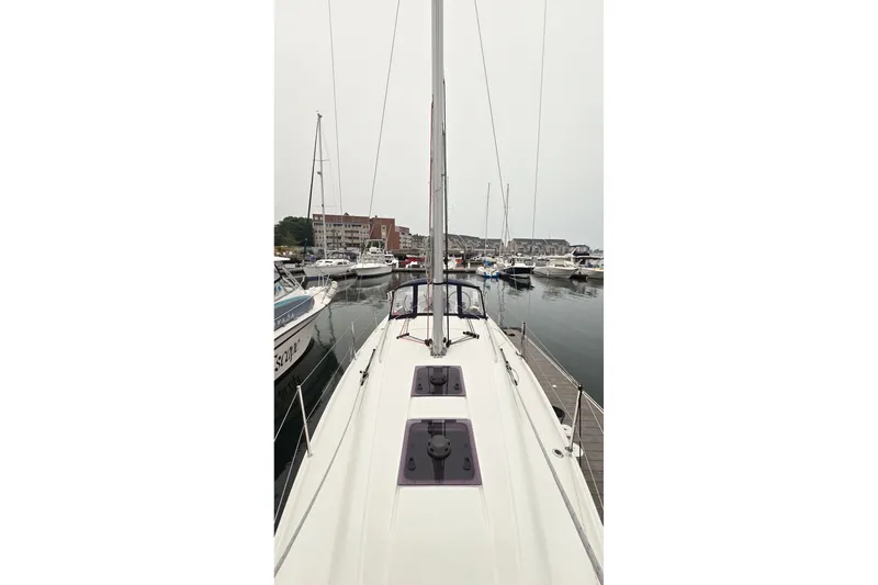Slide: The Image of 2022 Beneteau Oceanis 30.1 yacht docked in a marina, view from the deck. - 8