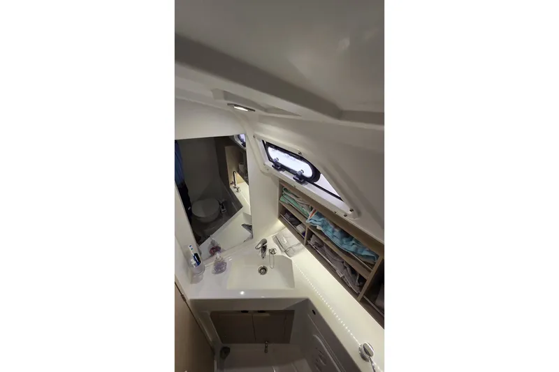 Slide: The Image of Interior view of 2022 Beneteau Oceanis 30.1 yacht bathroom with sink and storage. - 33