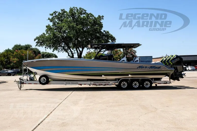 Slide: The Image of 2024 Nor-Tech 390 Sport Center Console boat on trailer, featuring sleek design and powerful engines. - 10