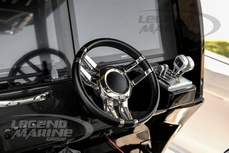 Slide: The Image of 2024 Nor-Tech 390 Sport Center Console helm with sleek steering wheel and advanced controls. - 14