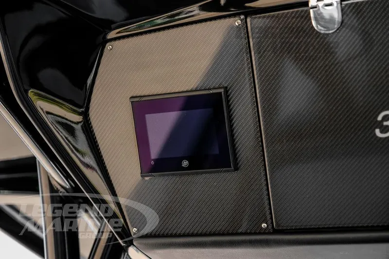 Slide: The Image of 2024 Nor-Tech 390 Sport Center Console with sleek carbon fiber panel and digital display. - 25