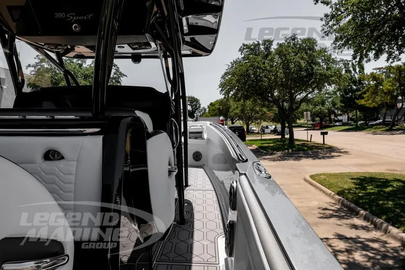 Slide: The Image of 2024 Nor-Tech 390 Sport Center Console boat, sleek design, parked on a sunny street. - 47