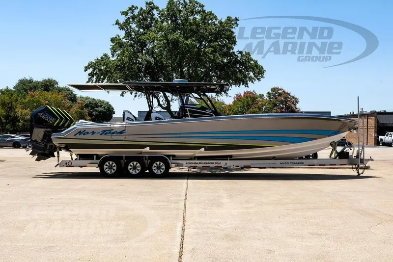 Slide: The Image of 2024 Nor-Tech 390 Sport Center Console boat on trailer, outdoors, side view. - 3