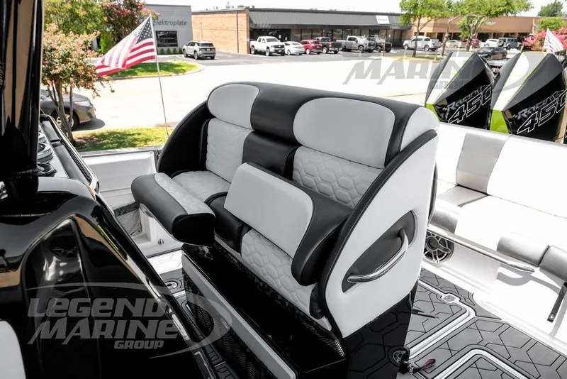 Slide: The Image of 2024 Nor-Tech 390 Sport Center Console boat interior with luxury seating and American flag. - 26