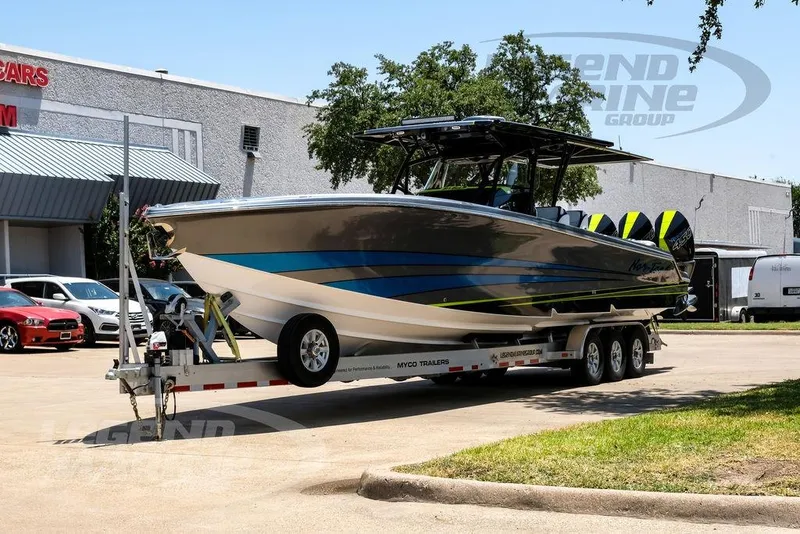 Slide: The Image of 2024 Nor-Tech 390 Sport Center Console boat on trailer, parked outdoors. - 6