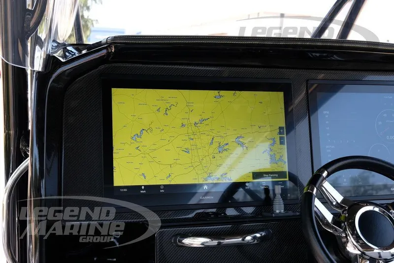 Slide: The Image of 2024 Nor-Tech 390 Sport Center Console dashboard with Garmin navigation display. - 10