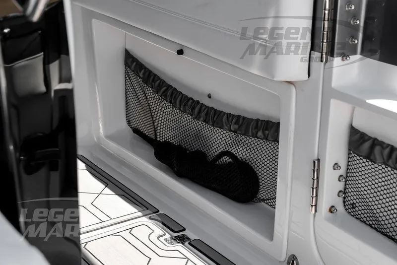Slide: The Image of 2024 Nor-Tech 390 Sport Center Console interior storage compartment with netting. - 51