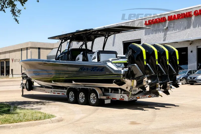 Slide: The Image of 2024 Nor-Tech 390 Sport Center Console boat on trailer outside dealership. - 6