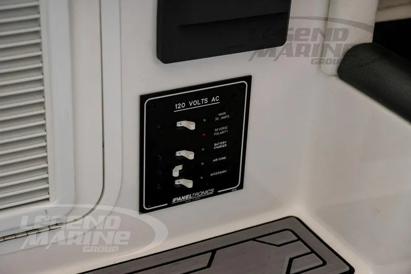 Slide: The Image of 2024 Nor-Tech 390 Sport Center Console electrical panel with 120 volts AC switches. - 59