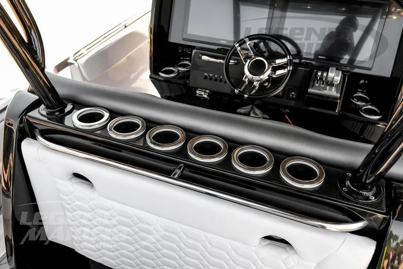 Slide: The Image of 2024 Nor-Tech 390 Sport Center Console interior with sleek dashboard and multiple cup holders. - 28