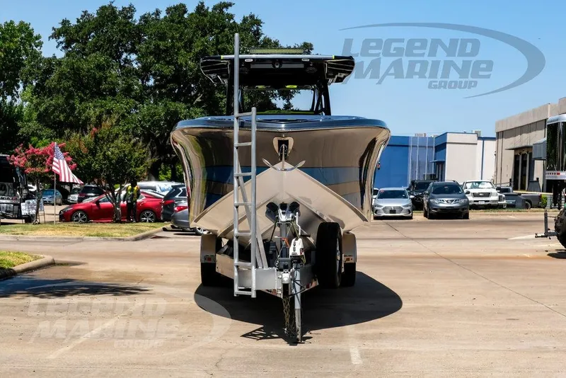 Slide: The Image of 2024 Nor-Tech 390 Sport Center Console boat on trailer in parking lot. - 11