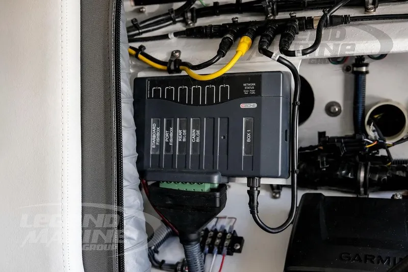 Slide: The Image of Electrical panel inside 2024 Nor-Tech 390 Sport Center Console boat, featuring wiring and connections. - 45