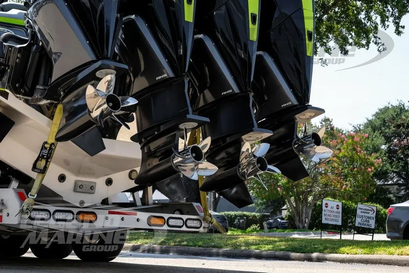 Slide: The Image of Four powerful outboard motors on a 2024 Nor-Tech 390 Sport Center Console boat. - 79