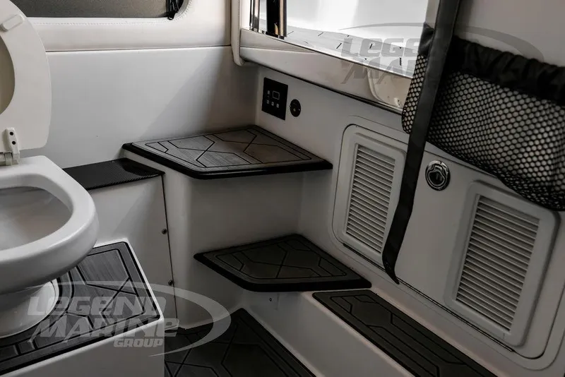 Slide: The Image of 2024 Nor-Tech 390 Sport Center Console interior with steps and storage compartments. - 60