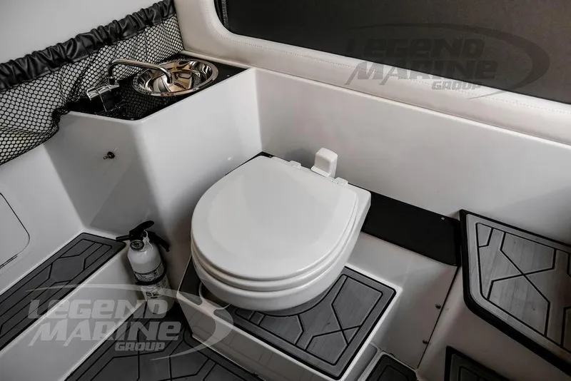 Slide: The Image of 2024 Nor-Tech 390 Sport Center Console interior with toilet and sink. - 56