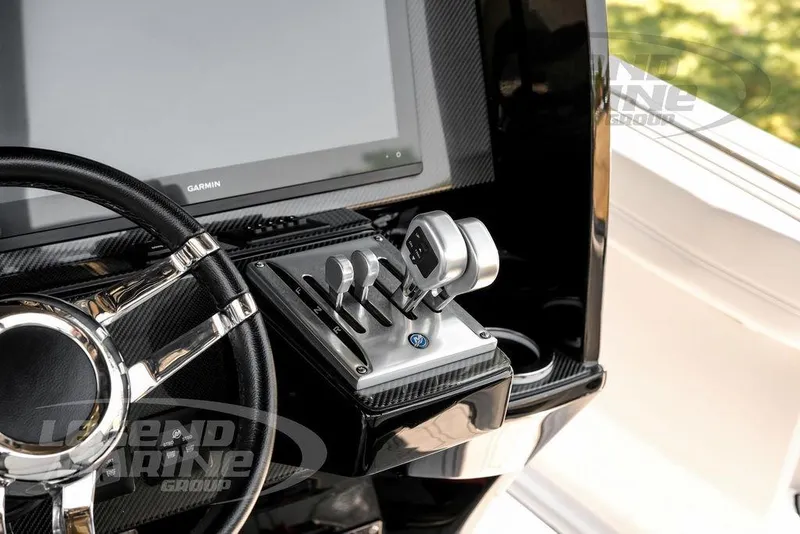 Slide: The Image of 2024 Nor-Tech 390 Sport Center Console helm with Garmin display and throttle controls. - 25