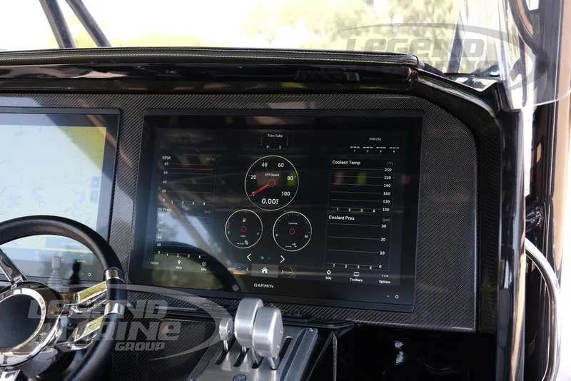 Slide: The Image of 2024 Nor-Tech 390 Sport Center Console dashboard with Garmin display and steering wheel. - 7